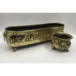 A large 19th century rectangular brass planter, with lion mask and ring handles. Profusely decorated