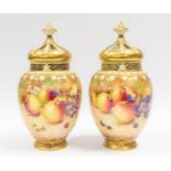 A pair of Royal Worcester pot pourri vases and covers, the baluster bodies painted with fallen