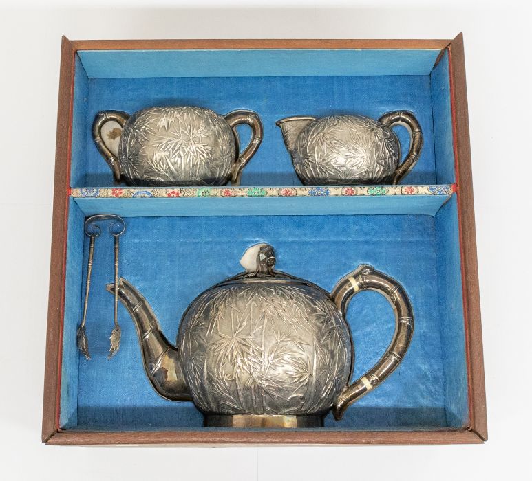 An early 20th Century Chinese Export silver three piece tea service and matching sugar tongs, - Image 2 of 4