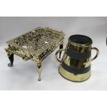 A 19th century brass footman trivet. Pierced top with star motif decoration, rope twist handles,