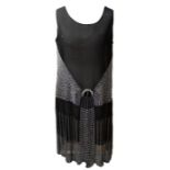 A 1920s Art Deco beaded dress, the black chiffon dress with a V bodice encrusted with large paste