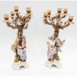 A pair of late 19th century Sitzendorf figural six light candelabra, the entire modelled as trees,