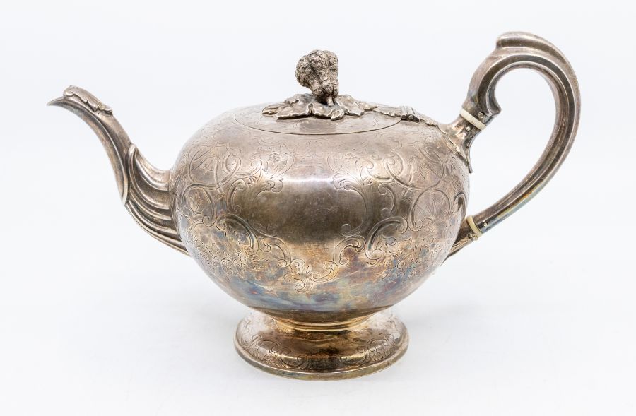 A Victorian Irish silver large bullet shaped teapot, engraved decoration to the body, the hinged