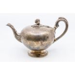 A Victorian Irish silver large bullet shaped teapot, engraved decoration to the body, the hinged