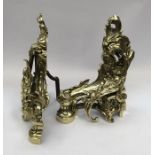 A pair of Neo-Classical cast gilt brass andirons. With ornate scroll and leaf decoration.