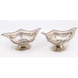 A matched pair of silver Victorian Neo-Classical baskets, border cast with anthemion and bell
