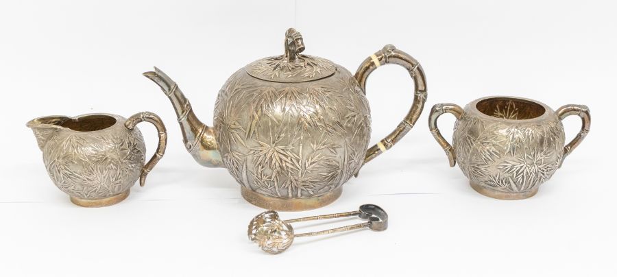 An early 20th Century Chinese Export silver three piece tea service and matching sugar tongs,