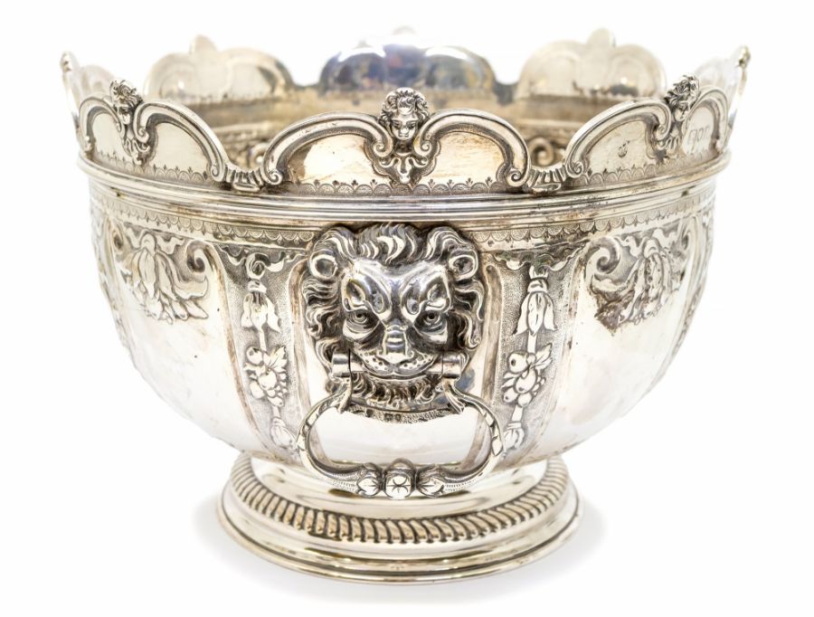 A Queen Anne style silver monteith / punch bowl, circular form with semi elliptical wavy edge cut