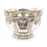A Queen Anne style silver monteith / punch bowl, circular form with semi elliptical wavy edge cut