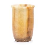An Egyptian, undated, alabaster cylindrical beaker, 12cm high  Further details: candle to interior