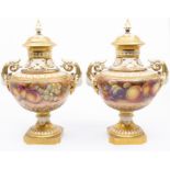 A pair of Royal Worcester two handled vase and covers, shape no: 1572, the bodies painted with