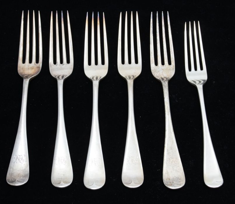 A collection of six early 20th Century silver Hanoverian pattern table forks, four engraved with