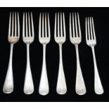 A collection of six early 20th Century silver Hanoverian pattern table forks, four engraved with