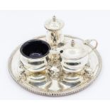 A Georgian style three piece silver condiment set comprising pepper, salt, mustard pot and cover,
