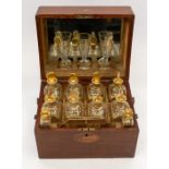 A George III inlaid mahogany travelling case complete with spirit decanter set comprising: eight