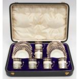 A set of six George VI silver mounted Aynsley china coffee cans with matching saucers, pattern no: