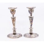 A pair of Modern silver plain candlesticks, detachable drip pans, urn shaped sconces above