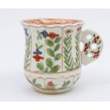 A Derby baluster cup, circa 1760, decorated with naive floral decoration within shield shaped