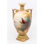 A Royal Worcester two handled vase, Hadley shape no: 249/H1157, the body decorated with pheasants