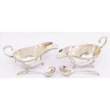 A pair of Georgian style silver oval sauceboats, gadroon borders on three shell and hoof feet, C-