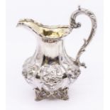 A William IV silver large cream / milk jug, lobed body chased and engraved with flowers and