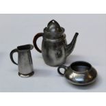 Tudric, a hammered pewter teapot with helmet cover and cane bound loop handle, 19cm, numbered