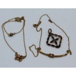 Two delicate yellow metal necklaces along with a 9c stamped garnet and seed pearl pendant