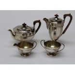 E S Barnsley and Co Ltd, a George v silver four piece tea service comprising tea and hot water pots,