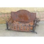 A cast and wrought iron fire grate with arched back and basket. Maximum dimensions, 40 x 73 x 36cm