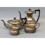A Victorian sterling silver tea set - comprising a tea pot, a water jug, a sugar bowl and milk