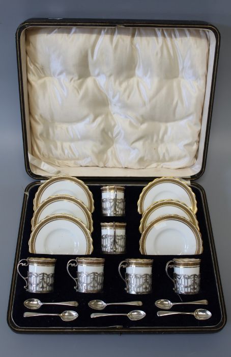 An Aynsley coffee set, in a Greek key pattern and gilded lobed rims, with sterling silver handles