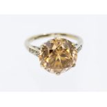 A golden zircon and diamond set 9ct gold solitaire ring, comprising a mixed round cut zircon