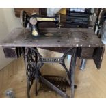 Singer Sewing Machine on cast iron treadle operated table. Some damage to woodwork.  THIS ITEM IS