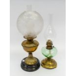 A late 19th century Art Nouveau brass and etched glass oil lamp together with another