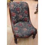 A 19th century mahogany nursing chair on castors