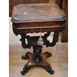 A mid-Victorian ornate mahogany sewing table with a lift-up top lid that reveals compartments and