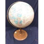 A mid 20th century globe on a stand