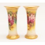 A pair of Royal Worcester hand painted Roses vases, signed M. Hunt, gilt detail, marked 15.54 to