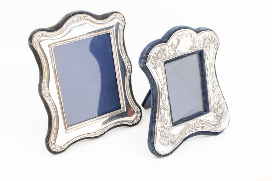 Two silver photo frames to include; A stylised floral Art Nouveau style silver easel form frame with