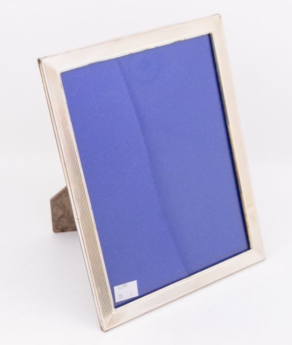 A large silver photo frame, with plain and ribbed design, hallmarked London, 1985, maker AB, approx.