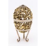 A Modern silver-gilt and silver limited edition Easter Egg on stand, the openwork body decorated