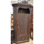 A 19th century carved oak hall robe with base drawer and top shelf, together with a matching hall