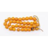 A butterscotch amber/resin type bead necklace, round beads each approx 12mm, total gross weight