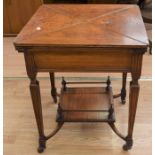 A mid 20th Century card table in oak having four brass-hinged quadrants to reveal a felt surface (