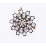 A Victorian diamond set brooch/pendant, flower form set to the centre with a rose cut diamond approx