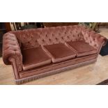 A mid 20th century three-seater button-back Chesterfield-style sofa
