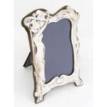 An Art Nouveau style silver photo frame with stylised figural and floral form, hallmarked London,
