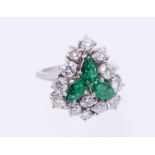 An emerald and diamond 18ct white gold cluster ring, comprising three pear cut emeralds set