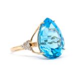 A large blue topaz and diamond 9ct gold ring, comprising a pear cut claw set blue topaz approx 15