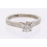 A diamond and platinum gold ring, comprising a round brilliant cut diamond, approx 0.87ct, clarity